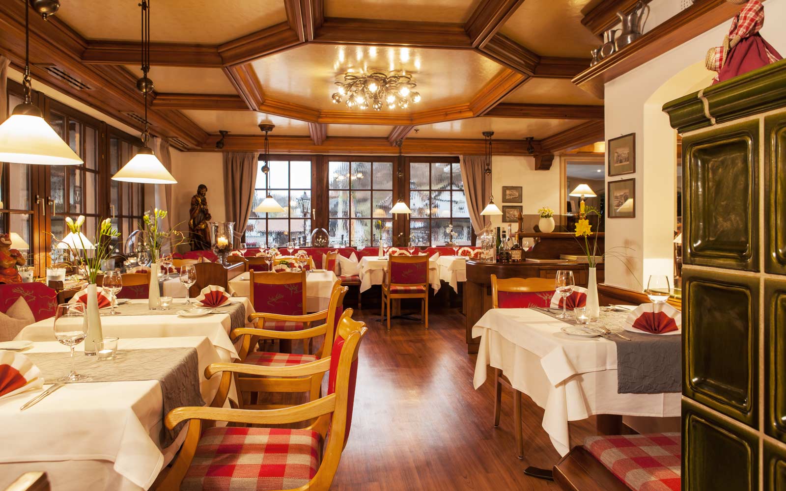 Gemütliches Restaurant mit Holzdecke und gedeckten Tischen